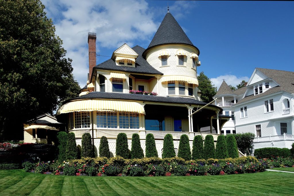 stunning old victorian house with a well-manicured lawn