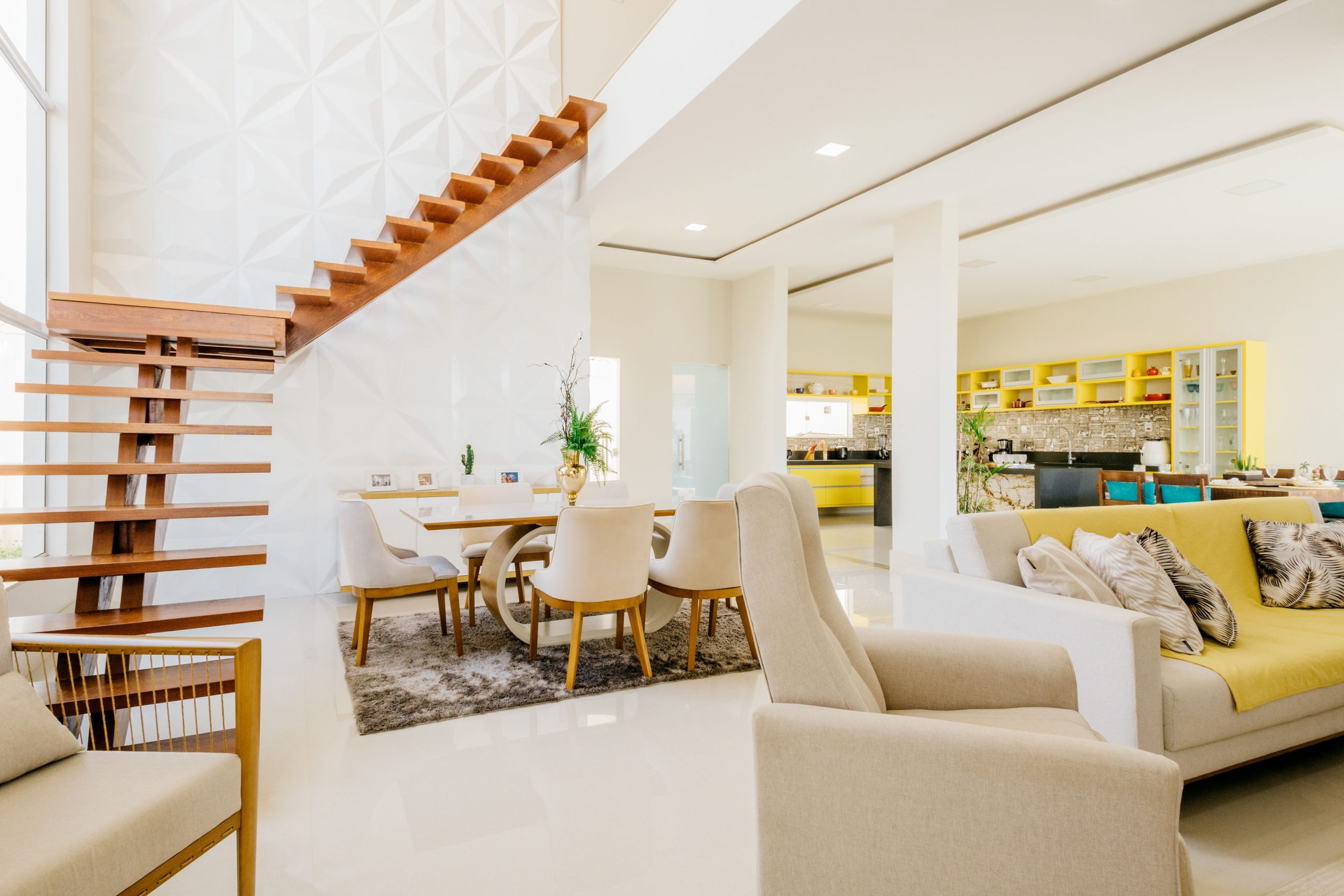 modern open concept living room with yellow accents